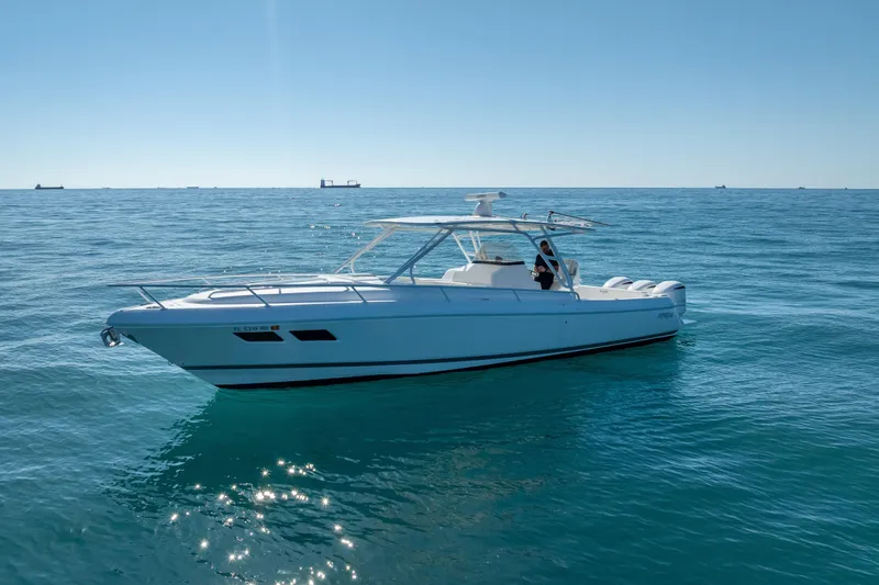 Slide: The Image of 2016 Intrepid 375 Center Console boat on calm ocean waters under clear blue sky. - 7