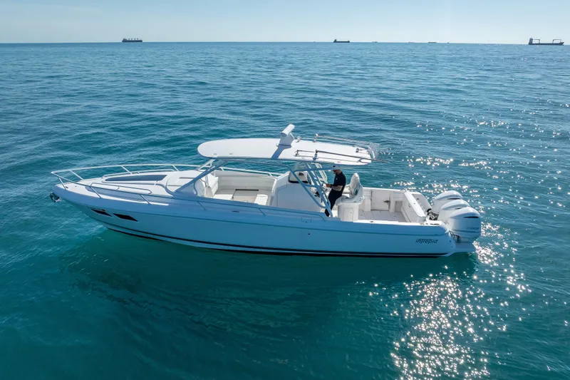 Slide: The Image of 2016 Intrepid 375 Center Console boat cruising on open blue water. - 8