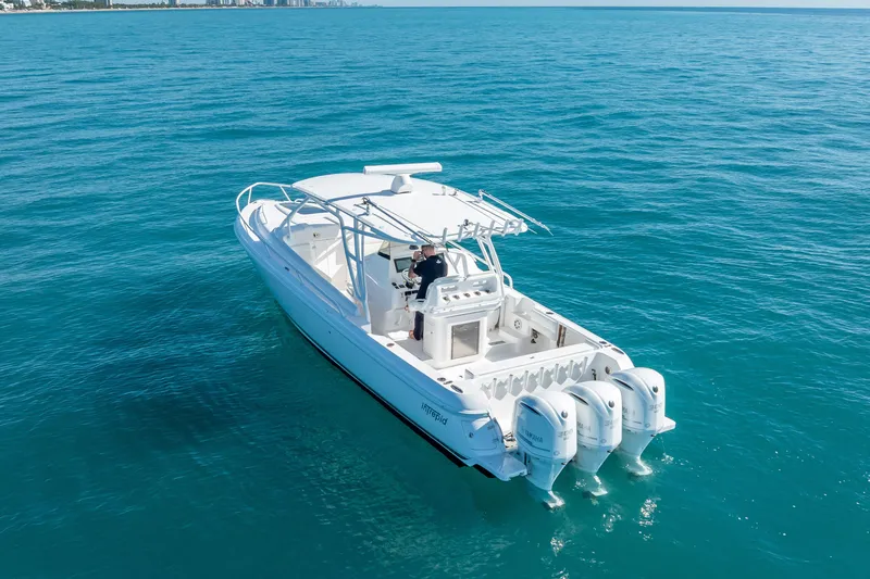 Slide: The Image of 2016 Intrepid 375 Center Console boat cruising on clear blue ocean waters. - 9