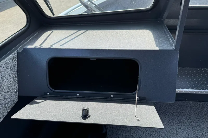 Slide: The Image of 2026 Alumaweld Intruder 22 boat interior storage compartment with open hatch. - 11