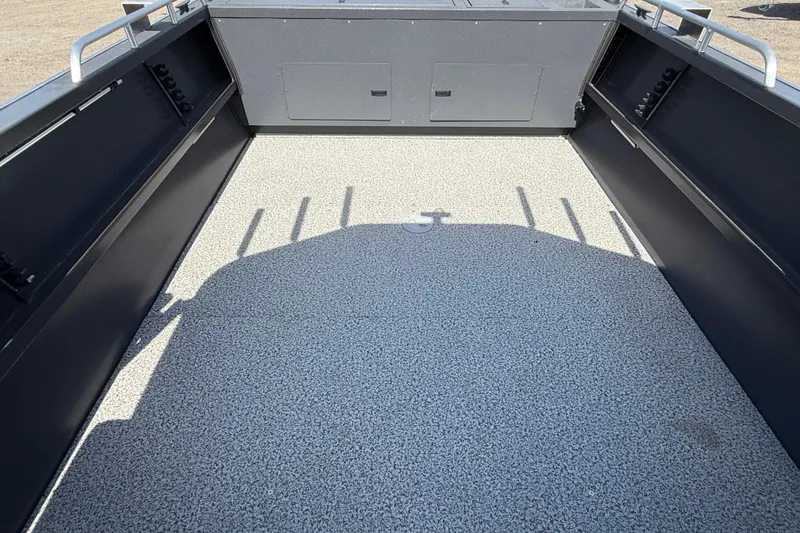 Slide: The Image of 2026 Alumaweld Intruder 22 boat interior with textured flooring and storage compartments. - 17