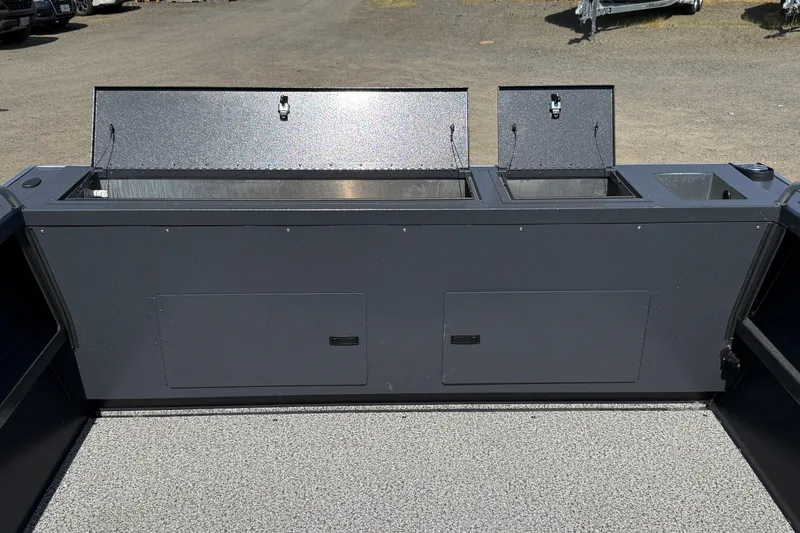 Slide: The Image of 2026 Alumaweld Intruder 22 boat interior with open storage compartments on a textured deck. - 18