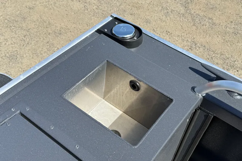 Slide: The Image of 2026 Alumaweld Intruder 22 boat detail showing a storage compartment and fuel cap. - 21
