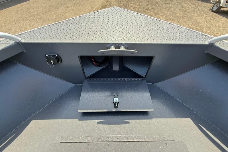 Slide: The Image of 2026 Alumaweld Intruder 22 boat interior with storage compartment and diamond plate flooring. - 23