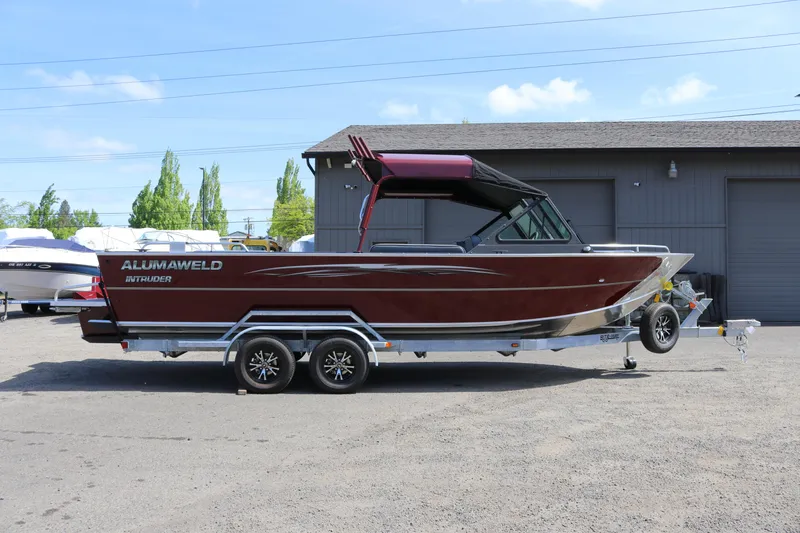 Slide: The Image of 2026 Alumaweld Intruder 22 boat on trailer, parked outdoors. - 3
