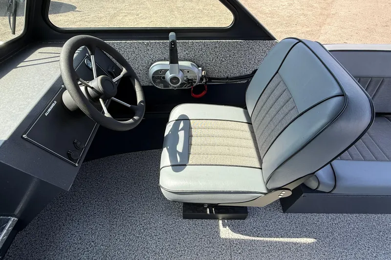 Slide: The Image of 2026 Alumaweld Intruder 22 boat interior with steering wheel and seat. - 7