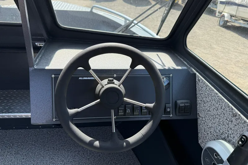 Slide: The Image of Steering wheel of 2026 Alumaweld Intruder 22 boat, showcasing dashboard controls and interior design. - 8