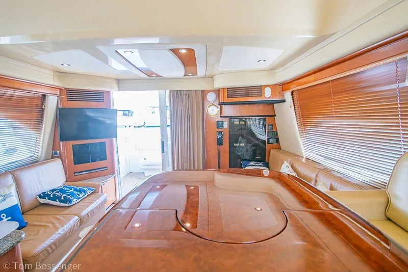 Slide: The Image of Luxurious interior of a 2005 Sea Ray 420 Sedan Bridge yacht with wood accents. - 12
