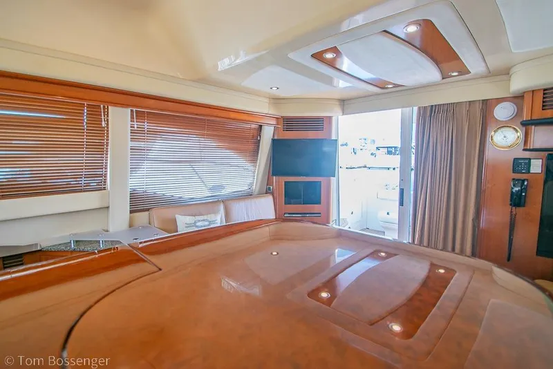 Slide: The Image of Luxurious interior of a 2005 Sea Ray 420 Sedan Bridge yacht with wood accents. - 13