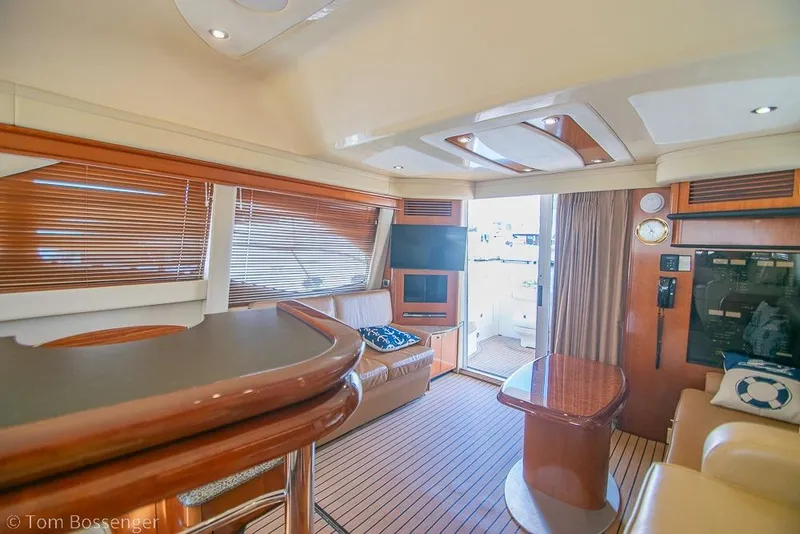 Slide: The Image of Luxurious interior of 2005 Sea Ray 420 Sedan Bridge yacht with elegant wood finishes. - 14