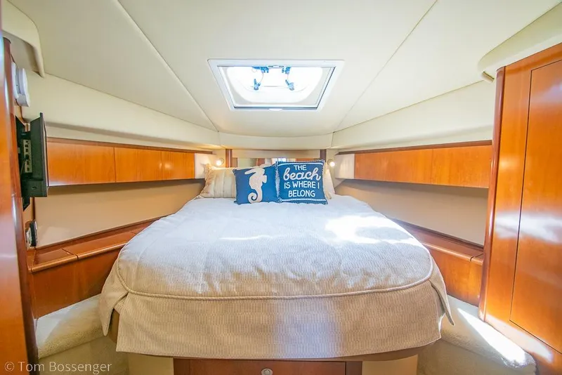 Slide: The Image of Luxurious cabin interior of 2005 Sea Ray 420 Sedan Bridge yacht with cozy bedding. - 21