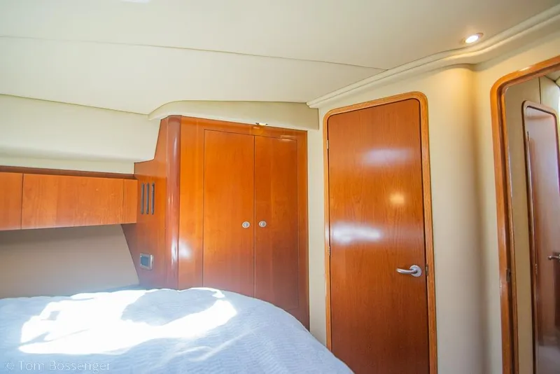 Slide: The Image of Interior cabin of 2005 Sea Ray 420 Sedan Bridge with wooden cabinetry and doors. - 23