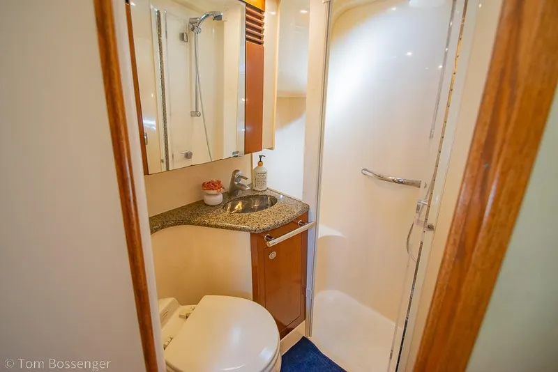 Slide: The Image of Bathroom interior of 2005 Sea Ray 420 Sedan Bridge yacht, featuring shower and sink. - 25