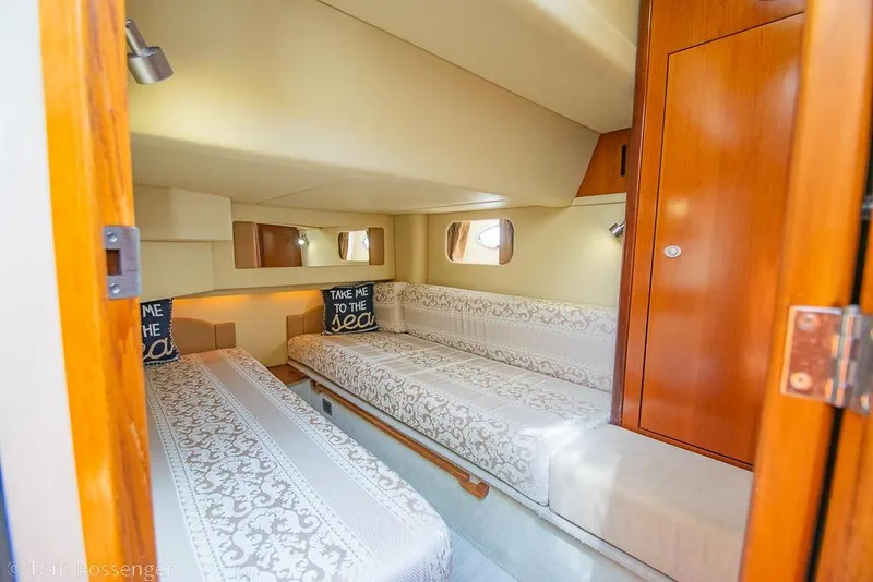 Slide: The Image of Luxurious 2005 Sea Ray 420 Sedan Bridge cabin with elegant bedding and wooden accents. - 26