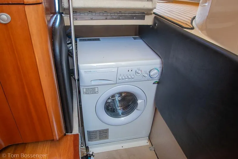 Slide: The Image of Compact washing machine inside 2005 Sea Ray 420 Sedan Bridge yacht interior. - 29