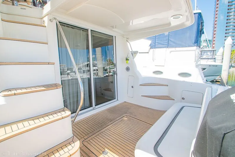 Slide: The Image of 2005 Sea Ray 420 Sedan Bridge yacht deck with teak flooring and sliding glass doors. - 35