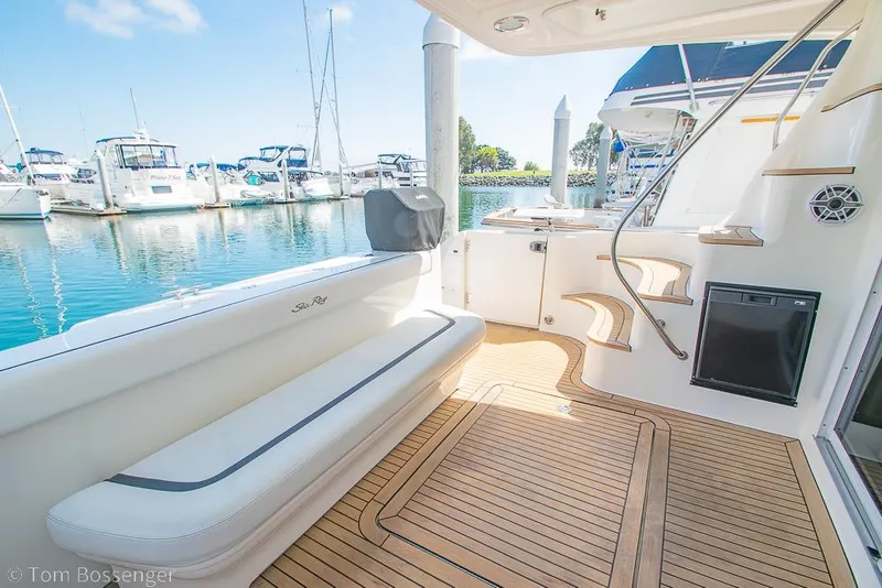 Slide: The Image of 2005 Sea Ray 420 Sedan Bridge yacht interior with teak flooring and marina view. - 37