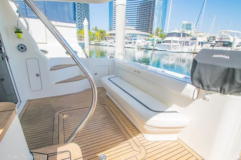 Slide: The Image of 2005 Sea Ray 420 Sedan Bridge yacht deck with seating, docked at marina. - 38