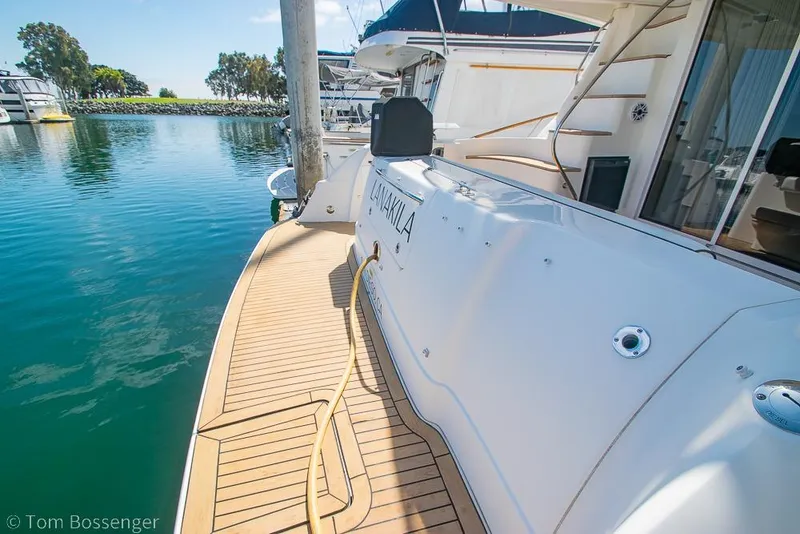 Slide: The Image of 2005 Sea Ray 420 Sedan Bridge yacht docked at marina, featuring teak deck. - 39