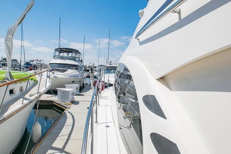 Slide: The Image of 2005 Sea Ray 420 Sedan Bridge yacht docked at marina under clear blue sky. - 40