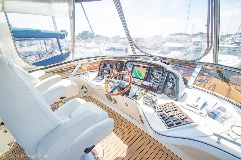 Slide: The Image of Helm of 2005 Sea Ray 420 Sedan Bridge with navigation equipment and luxurious seating. - 43