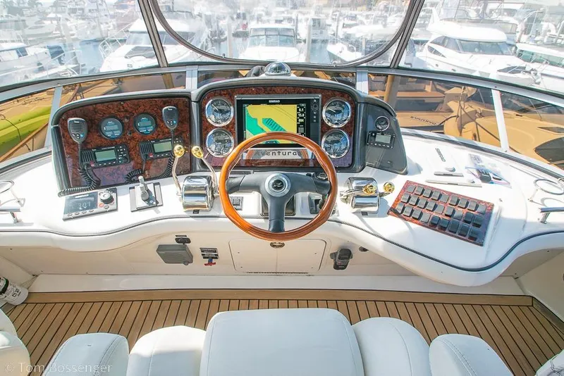 Slide: The Image of Cockpit of 2005 Sea Ray 420 Sedan Bridge with navigation instruments and wooden steering wheel. - 45