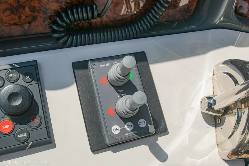 Slide: The Image of Control panel of a 2005 Sea Ray 420 Sedan Bridge boat, featuring joystick and throttle controls. - 46