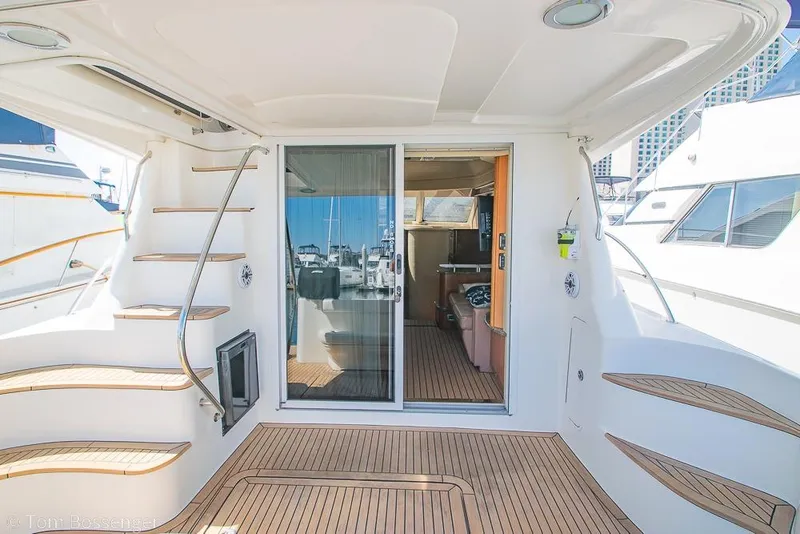 Slide: The Image of 2005 Sea Ray 420 Sedan Bridge yacht interior with wooden deck and staircase. - 5