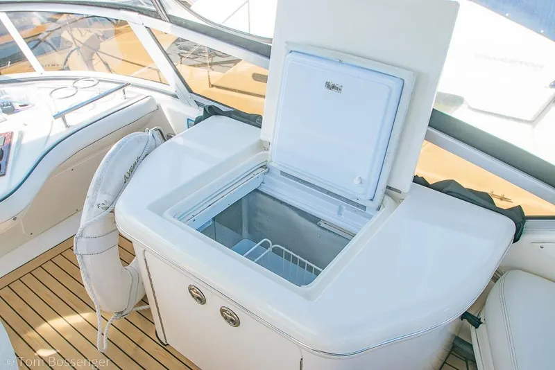 Slide: The Image of 2005 Sea Ray 420 Sedan Bridge yacht interior with open cooler on teak deck. - 52