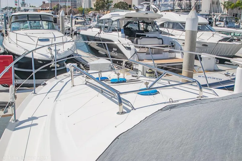 Slide: The Image of 2005 Sea Ray 420 Sedan Bridge yacht docked at a marina with other boats. - 53