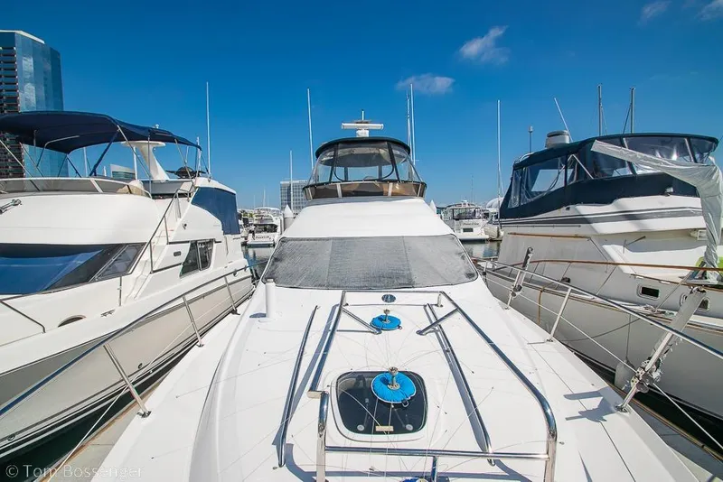 Slide: The Image of 2005 Sea Ray 420 Sedan Bridge yacht docked at marina under clear blue sky. - 54