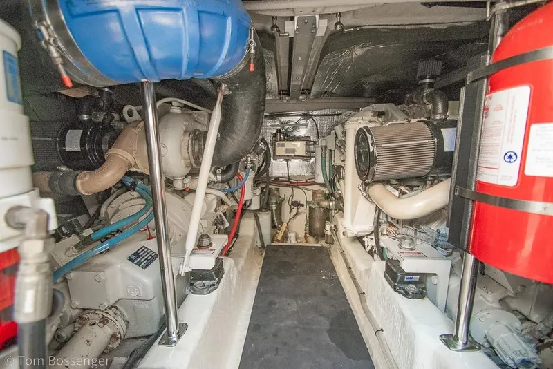Slide: The Image of Engine room of a 2005 Sea Ray 420 Sedan Bridge with visible machinery and equipment. - 56