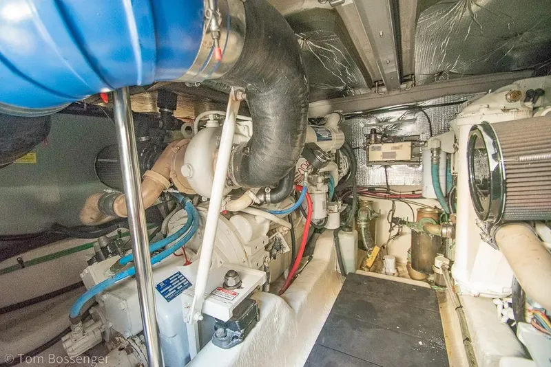 Slide: The Image of Engine room of a 2005 Sea Ray 420 Sedan Bridge, showcasing mechanical components and wiring. - 57