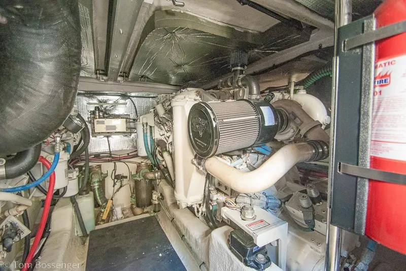 Slide: The Image of Engine room of a 2005 Sea Ray 420 Sedan Bridge, showcasing mechanical components. - 58