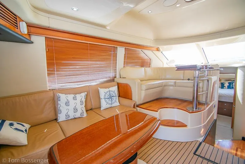 Slide: The Image of Luxurious interior of 2005 Sea Ray 420 Sedan Bridge yacht with leather seating and wooden accents. - 7