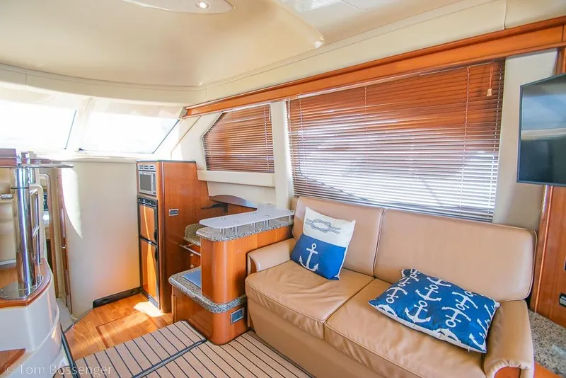 Slide: The Image of Luxurious interior of 2005 Sea Ray 420 Sedan Bridge with leather seating and nautical decor. - 8