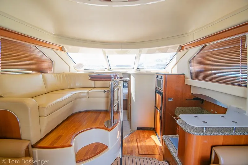Slide: The Image of Luxurious interior of 2005 Sea Ray 420 Sedan Bridge yacht with leather seating and wood finishes. - 9