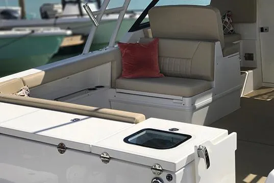 Slide: The Image of Manufacturer Provided Image: 2019 Everglades 340 Dual Console boat interior with beige seating and red cushion. - 17
