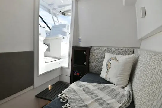 Slide: The Image of Manufacturer Provided Image: Interior cabin of 2019 Everglades 340 Dual Console boat with seating and decor. - 19