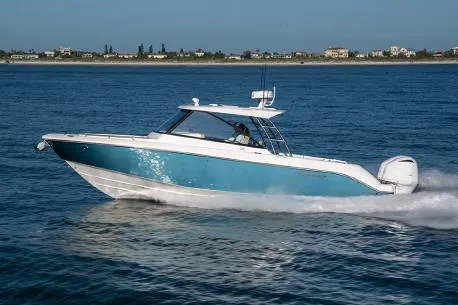 Slide: The Image of Manufacturer Provided Image: 2019 Everglades 340 Dual Console boat cruising on open water. - 2