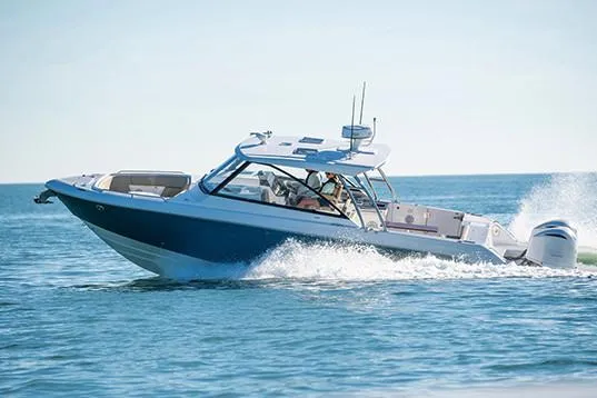 Slide: The Image of Manufacturer Provided Image: 2019 Everglades 340 Dual Console boat cruising on open water. - 5