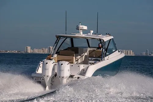 Slide: The Image of Manufacturer Provided Image: 2019 Everglades 340 Dual Console boat cruising on open water. - 7