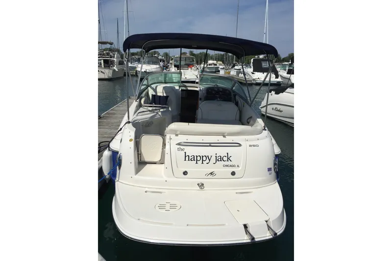 Slide: The Image of 2006 Monterey 250 Cruiser docked at marina, rear view with canopy and seating. - 1