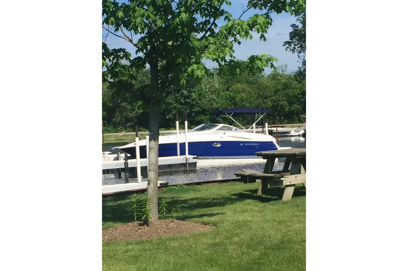 Slide: The Image of 2006 Monterey 250 Cruiser docked by a tree and picnic table. - 11