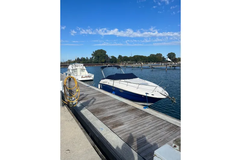 Slide: The Image of 2006 Monterey 250 Cruiser docked at a marina under a clear blue sky. - 3