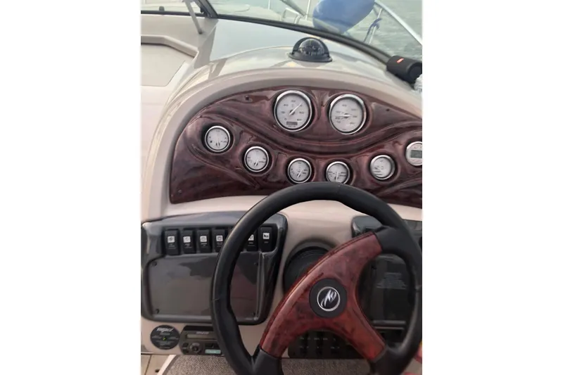 Slide: The Image of Steering wheel and dashboard of a 2006 Monterey 250 Cruiser boat. - 6