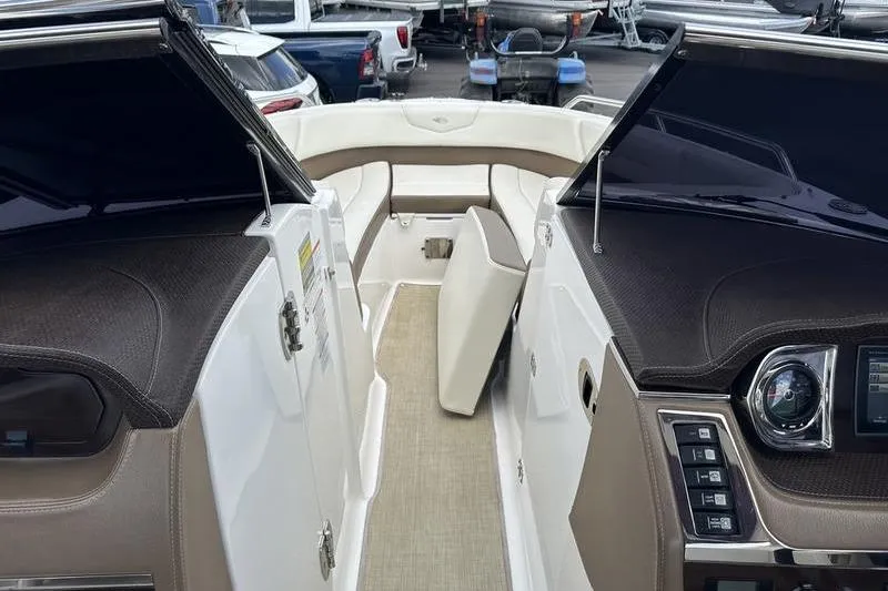 Slide: The Image of Interior view of a 2015 Chaparral 257 SSX boat, featuring seating and dashboard controls. - 11
