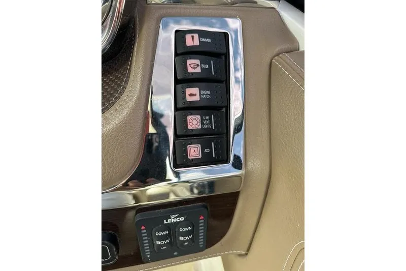 Slide: The Image of Control panel of a 2015 Chaparral 257 SSX boat with various switches and buttons. - 13