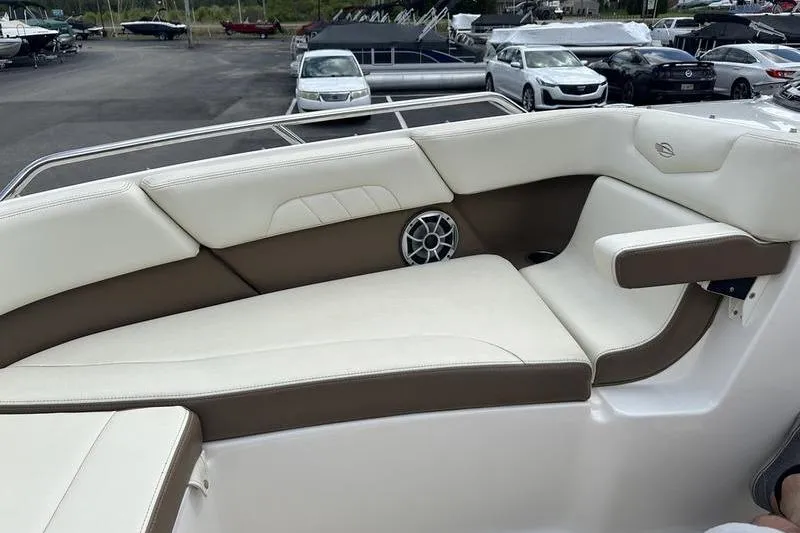 Slide: The Image of 2015 Chaparral 257 SSX boat interior with white and brown seating, featuring a speaker. - 19