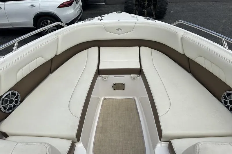 Slide: The Image of Bow seating area of a 2015 Chaparral 257 SSX boat with white and brown upholstery. - 2